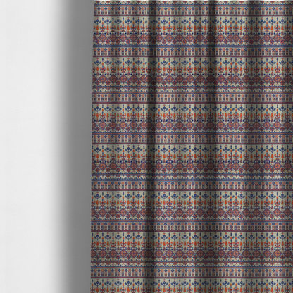 The fabric used to create these made-to-measure curtains is a intricate folk-inspired fabric featuring horizontal bands of geometric diamonds, stylized birds, and floral motifs in navy blue and rust orange on a beige background.