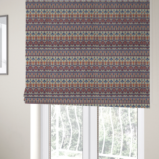 The fabric used to create these Roman blinds is an intricate folk-inspired fabric featuring horizontal bands of geometric diamonds, stylized birds, and floral motifs in navy blue and rust orange on a beige background.