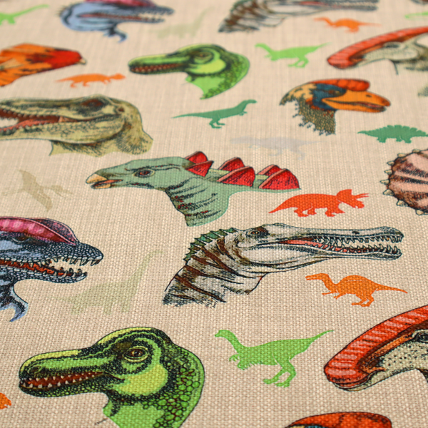 Several distinct dinosaur heads are scattered across the pattern, including detailed illustrations of a Triceratops with horns, a green Tyrannosaurus rex with textured skin, a long-snouted Parasaurolophus with a prominent crest, a blue-headed theropod with a pink crest, an orange-headed ceratopsian, and a Spinosaurus with a crocodile-like snout.