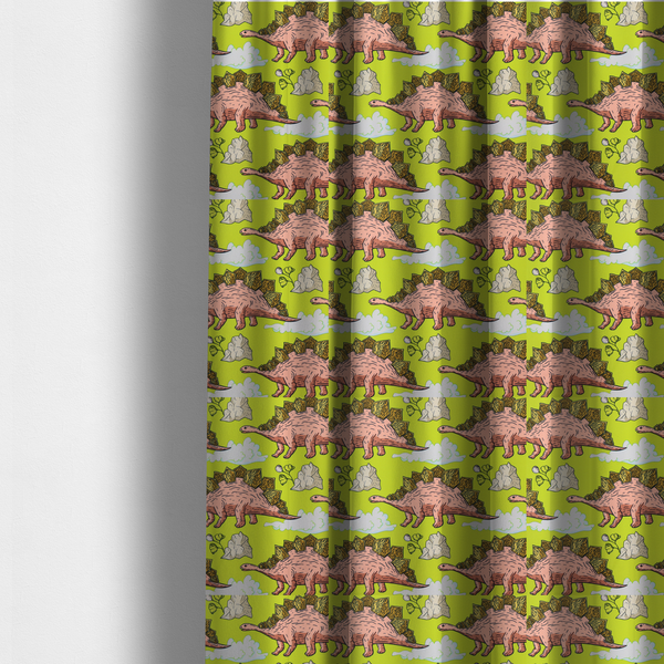 The fabric used to create these made-to-measure curtains is a repeating pattern on a vibrant green background featuring pink Stegosaurus dinosaurs with golden plates, interspersed with light grey rocks, fluffy white clouds, and small green sprigs.