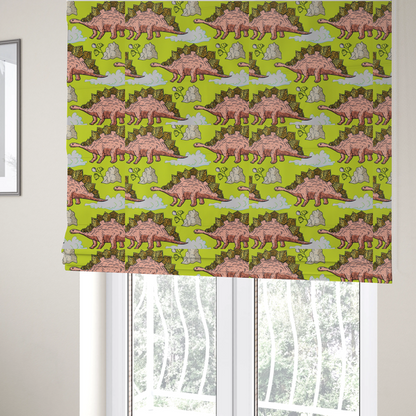 The fabric used to create these Roman blinds is a repeating pattern on a vibrant green background featuring pink Stegosaurus dinosaurs with golden plates, interspersed with light grey rocks, fluffy white clouds, and small green sprigs.
