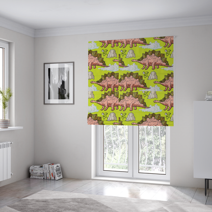 The fabric used to create these Roman blinds is a repeating pattern on a vibrant green background featuring pink Stegosaurus dinosaurs with golden plates, interspersed with light grey rocks, fluffy white clouds, and small green sprigs.