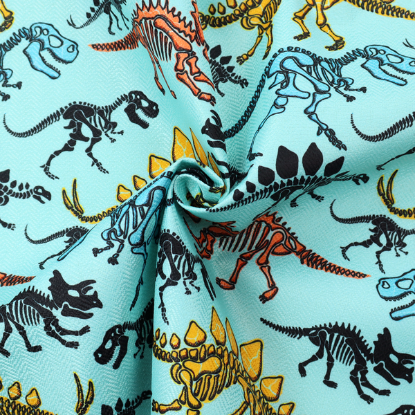A repeating pattern on a light blue background featuring colourful dinosaur skeletons in yellow, orange, blue, and black, depicting various species including Stegosaurus, Triceratops, and Tyrannosaurus rex.