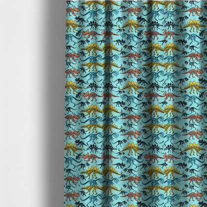 The fabric used to create these made-to-measure curtains is a repeating pattern on a light blue background featuring colourful dinosaur skeletons in yellow, orange, blue, and black, depicting various species including Stegosaurus, Triceratops, and Tyrannosaurus rex.