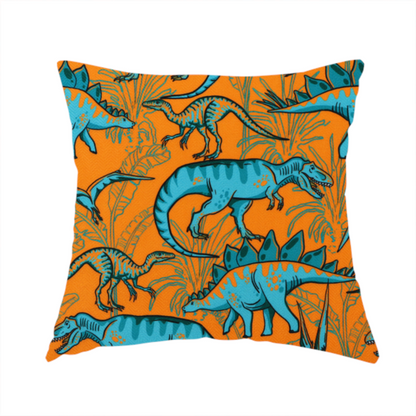 The fabric used to create this handmade cushion is a repeating pattern on a bright orange background featuring blue dinosaurs, including Stegosaurus, T-Rex, and pterosaurs, set against a backdrop of palm leaves and tropical foliage.