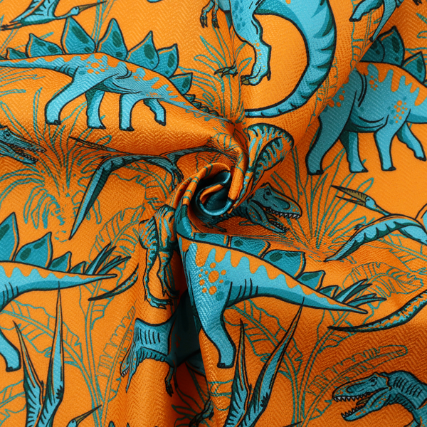 A repeating pattern on a bright orange background featuring blue dinosaurs, including Stegosaurus, T-Rex, and pterosaurs, set against a backdrop of palm leaves and tropical foliage.