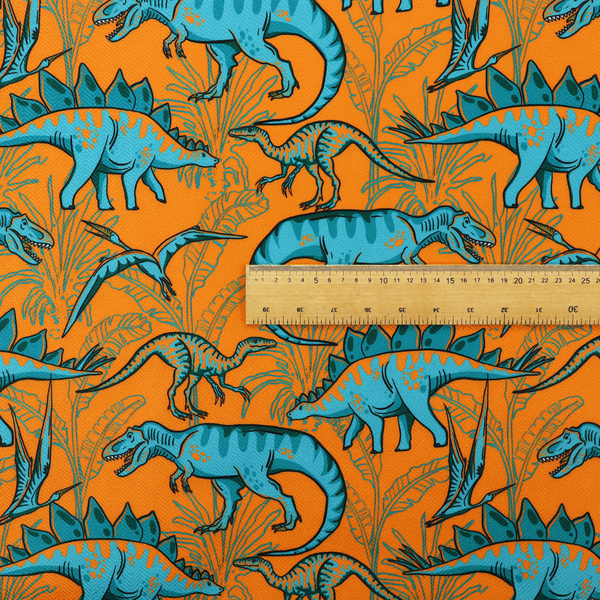 A repeating pattern on a bright orange background featuring blue dinosaurs, including Stegosaurus, T-Rex, and pterosaurs, set against a backdrop of palm leaves and tropical foliage.