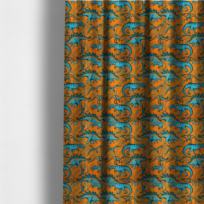 The fabric used to create these made-to-measure curtains is a repeating pattern on a bright orange background featuring blue dinosaurs, including Stegosaurus, T-Rex, and pterosaurs, set against a backdrop of palm leaves and tropical foliage.