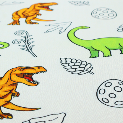 A repeating pattern on a light grey-blue background featuring orange Tyrannosaurus rex dinosaurs, a bright green long-necked sauropod, speckled dinosaur eggs, pinecones, footprints, and leafy sprigs.