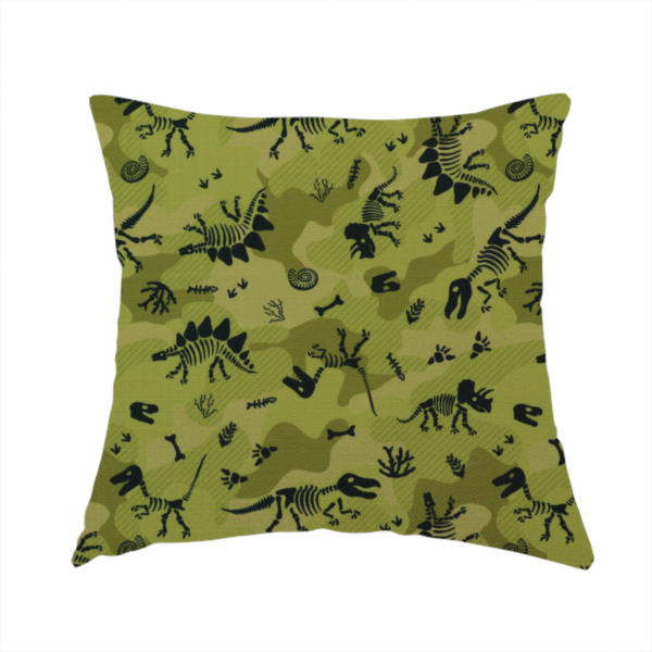 The fabric used to create this handmade cushion is a military-style green camouflage pattern featuring repeating black dinosaur skeletons, bones, footprints, and fossils.