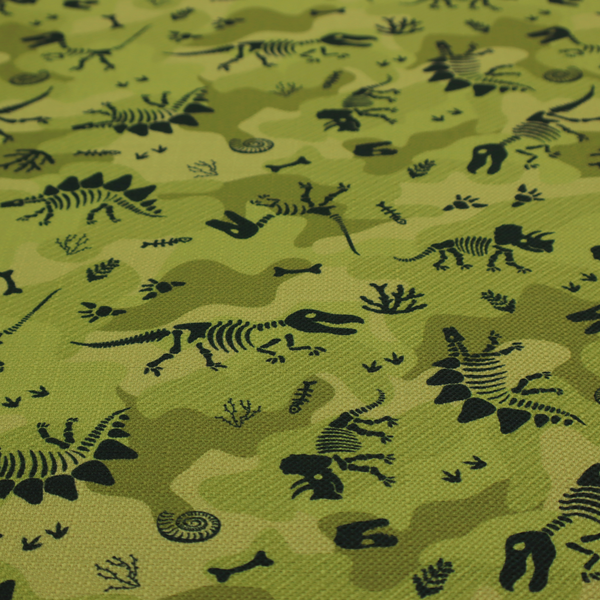 A military-style green camouflage pattern featuring repeating black dinosaur skeletons, bones, footprints, and fossils.