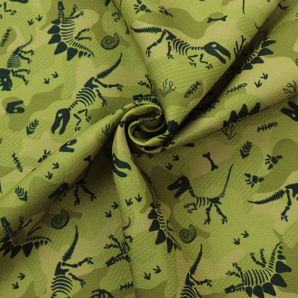 A military-style green camouflage pattern featuring repeating black dinosaur skeletons, bones, footprints, and fossils.