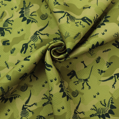 A military-style green camouflage pattern featuring repeating black dinosaur skeletons, bones, footprints, and fossils.