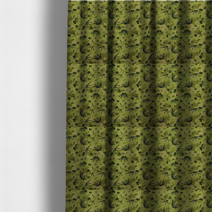 The fabric used to create these made-to-measure curtains is a military-style green camouflage pattern featuring repeating black dinosaur skeletons, bones, footprints, and fossils.