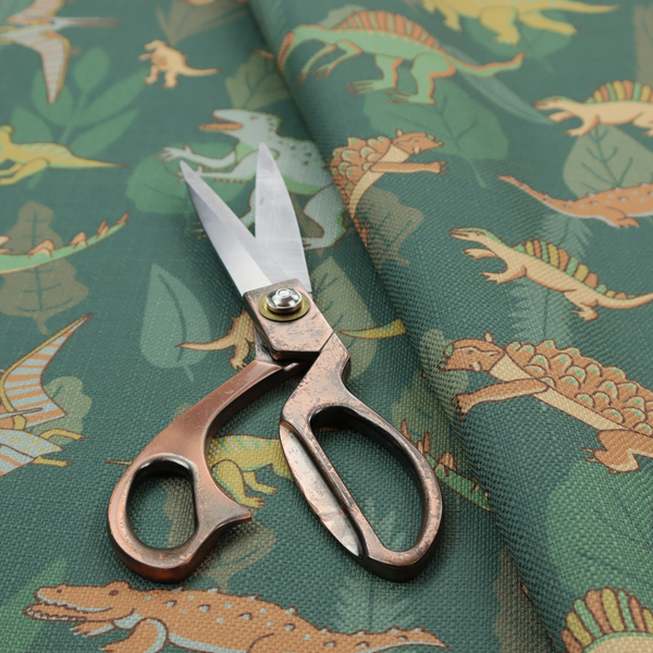 A playful dinosaur pattern on a deep teal background featuring various illustrated dinosaurs and lush tropical leaves.