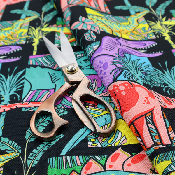 A bold repeating pattern on a black background featuring colourful dinosaurs, including pink, yellow, teal, and purple species, framed within geometric panels and surrounded by tropical foliage.