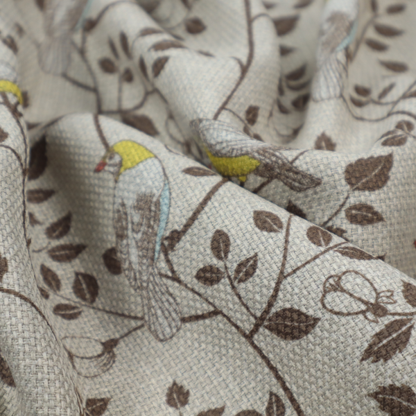 Vintage-style botanical fabric featuring yellow-bellied songbirds perched on climbing brown vines and rosebuds against a textured grey background.