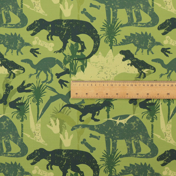 A textured, distressed green and olive camouflage pattern featuring repeating silhouettes of dinosaurs, bones, footprints, and palm fronds.