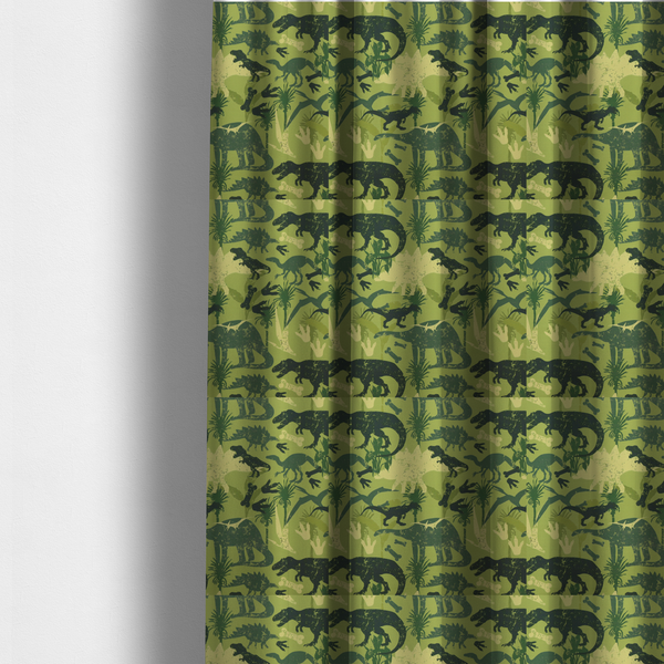 The fabric used to create these made-to-measure curtains is a textured, distressed green and olive camouflage pattern featuring repeating silhouettes of dinosaurs, bones, footprints, and palm fronds.