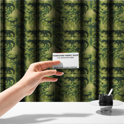 The fabric used to create these made-to-measure curtains is a textured, distressed green and olive camouflage pattern featuring repeating silhouettes of dinosaurs, bones, footprints, and palm fronds.