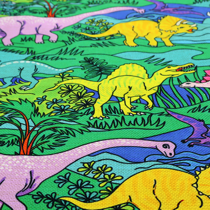 A vibrant, colourful repeating pattern featuring various cartoon dinosaurs including a pink long-neck, yellow triceratops, green T-Rex, and flying pterodactyls amidst a prehistoric landscape.