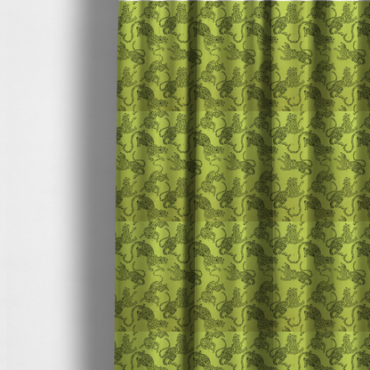 The fabric used to create these made-to-measure curtains is a seamless repeating pattern featuring black stylized leopards or jaguars printed over a vibrant lime green background. The felines are depicted in a dynamic, crouching or leaping pose with detailed spotted markings and long, curving tails.