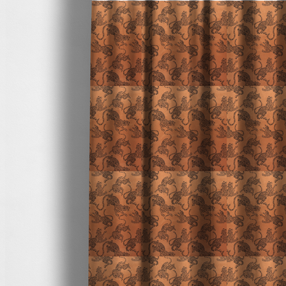 The fabric used to create these made-to-measure curtains is a seamless repeating pattern featuring black stylized leopards or jaguars printed over a warm terracotta or burnt orange background. The felines are depicted in a dynamic, crouching or leaping pose with detailed spotted markings and long, curving tails.