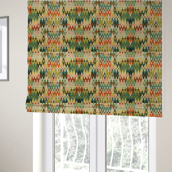 The fabric used to create these Roman blinds is a seamless geometric upholstery fabric pattern featuring an intricate, symmetrical Aztec-inspired motif of interlocking diamonds and vertical zigzags in earthy tones of green, rust, mustard yellow, and peach.
