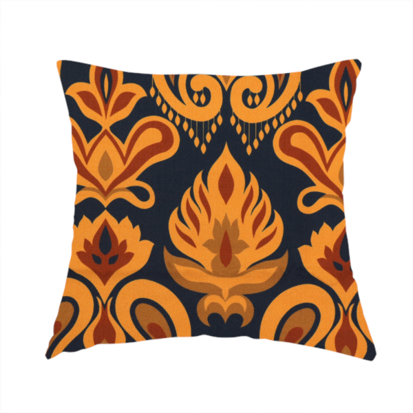 The fabric used to create this handmade cushion is a decorative upholstery fabric with a repeating Ikat-style floral motif. The colour palette consists of Mustard Gold, Rust, and Earthy Brown on a Midnight Black woven base, featuring stylized teardrop swirls and geometric petal patterns.