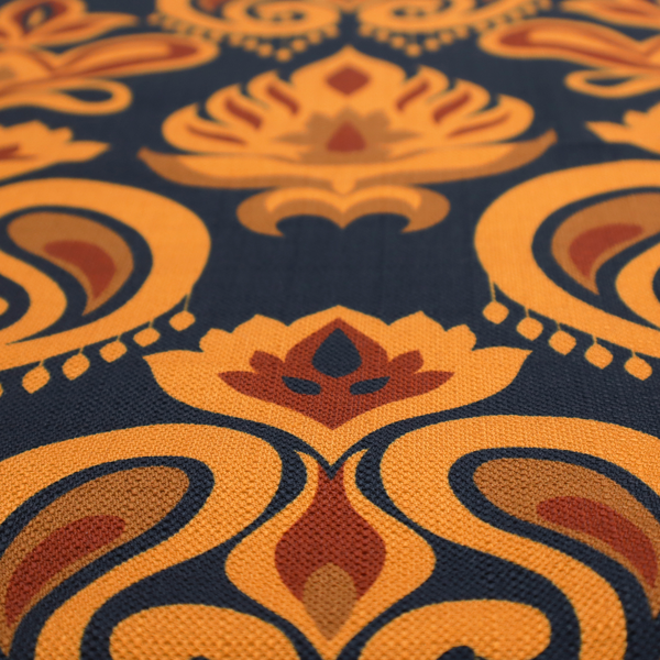 Close-up of a decorative upholstery fabric with a repeating Ikat-style floral motif. The colour palette consists of Mustard Gold, Rust, and Earthy Brown on a Midnight Black woven base, featuring stylized teardrop swirls and geometric petal patterns.