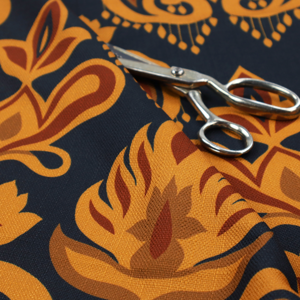 Close-up of a decorative upholstery fabric with a repeating Ikat-style floral motif. The colour palette consists of Mustard Gold, Rust, and Earthy Brown on a Midnight Black woven base, featuring stylized teardrop swirls and geometric petal patterns.
