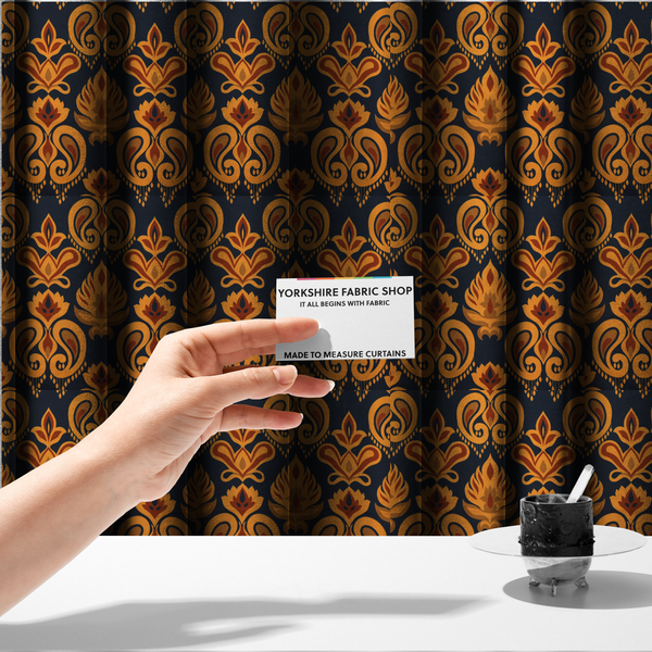 The fabric used to create these made-to-measure curtains is a decorative upholstery fabric with a repeating Ikat-style floral motif. The colour palette consists of Mustard Gold, Rust, and Earthy Brown on a Midnight Black woven base, featuring stylized teardrop swirls and geometric petal patterns.