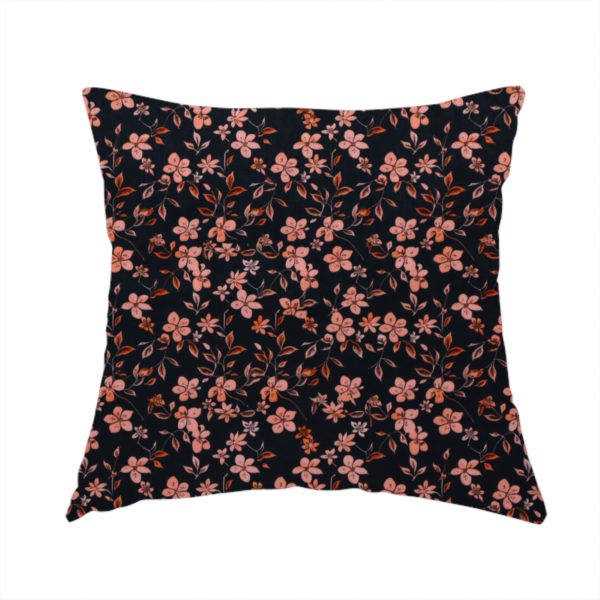 The fabric used to create this handmade cushion is a seamless repeating botanical pattern featuring small pinkish-peach flowers and delicate leafy branches set against a dark, near-black background.