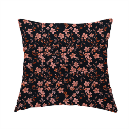 The fabric used to create this handmade cushion is a seamless repeating botanical pattern featuring small pinkish-peach flowers and delicate leafy branches set against a dark, near-black background.