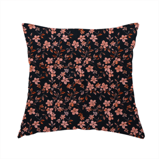 The fabric used to create this handmade cushion is a seamless repeating botanical pattern featuring small pinkish-peach flowers and delicate leafy branches set against a dark, near-black background.