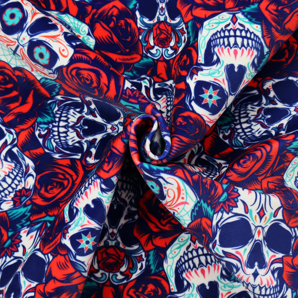 A vibrant repeating pattern on a dark background featuring decorated sugar skulls with intricate blue and red designs, surrounded by deep red roses and green leaves.