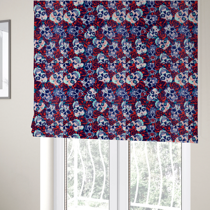 The fabric used to create these Roman blinds is a vibrant repeating pattern on a dark background featuring decorated sugar skulls with intricate blue and red designs, surrounded by deep red roses and green leaves.