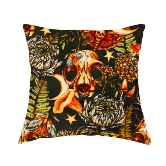 The fabric used to create this handmade cushion is a dark and mystical repeating pattern featuring animal skulls, crescent moons, stars, moths, ferns, and chrysanthemums in warm golden and orange tones.