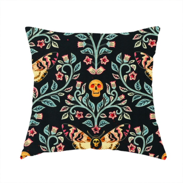 The fabric used to create this handmade cushion is a symmetrical, damask-style repeating pattern on a black background featuring death's-head hawkmoths, human skulls, and ornate scrolling blue-green vines with pink and red flowers.