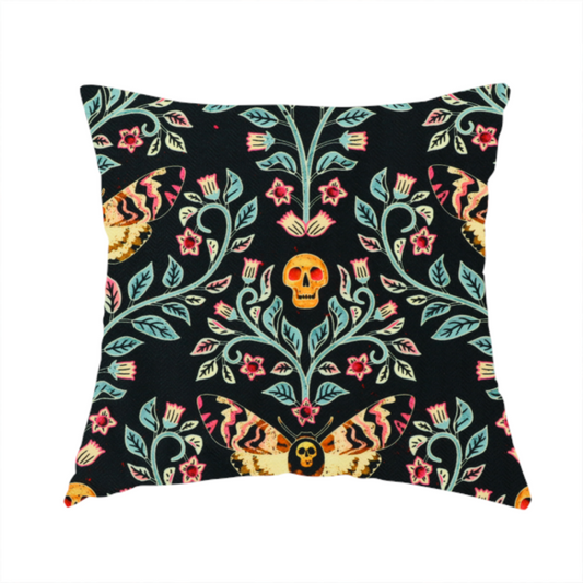 The fabric used to create this handmade cushion is a symmetrical, damask-style repeating pattern on a black background featuring death's-head hawkmoths, human skulls, and ornate scrolling blue-green vines with pink and red flowers.