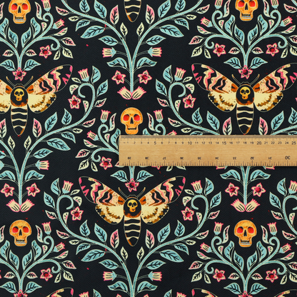 A symmetrical, damask-style repeating pattern on a black background featuring death's-head hawkmoths, human skulls, and ornate scrolling blue-green vines with pink and red flowers.