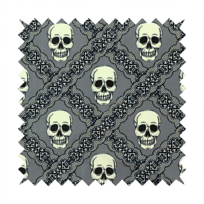 A repeating pattern on a grey background featuring off-white human skulls arranged in a grid, separated by diagonal intersecting bands of ornate black lace with intricate scrollwork.