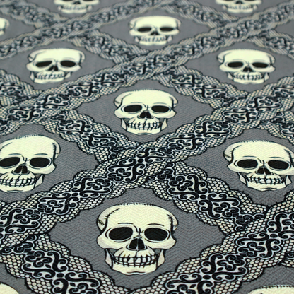 A repeating pattern on a grey background featuring off-white human skulls arranged in a grid, separated by diagonal intersecting bands of ornate black lace with intricate scrollwork.
