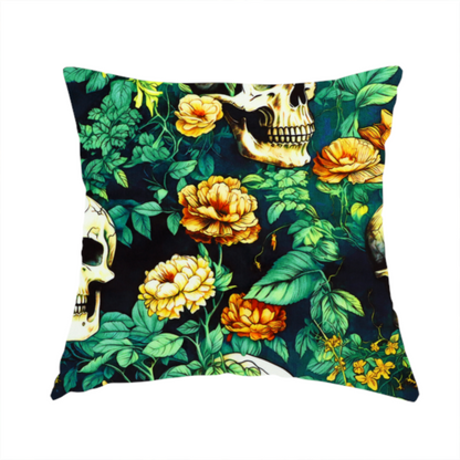 The fabric used to create this handmade cushion is a detailed repeating pattern on a dark background featuring ivory human skulls entwined with vibrant green leafy vines and blooming yellow and orange flowers.