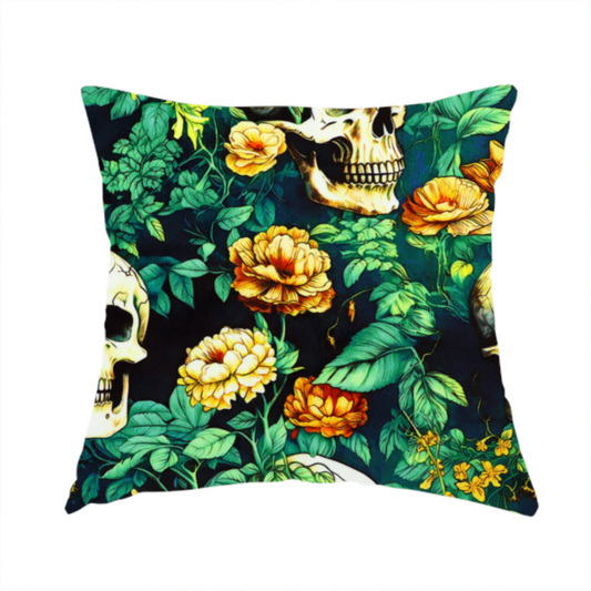 The fabric used to create this handmade cushion is a detailed repeating pattern on a dark background featuring ivory human skulls entwined with vibrant green leafy vines and blooming yellow and orange flowers.