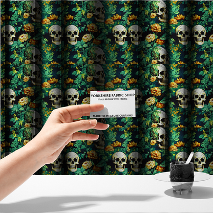 The fabric used to create these made-to-measure curtains is a detailed repeating pattern on a dark background featuring ivory human skulls entwined with vibrant green leafy vines and blooming yellow and orange flowers.