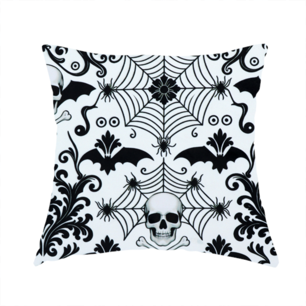 The fabric used to create this handmade cushion is a spooky, ornate damask-style repeating pattern on a white background featuring black skulls, bats, spiderwebs with small spiders, and crossbones.