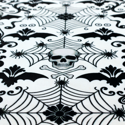 A spooky, ornate damask-style repeating pattern on a white background featuring black skulls, bats, spiderwebs with small spiders, and crossbones.