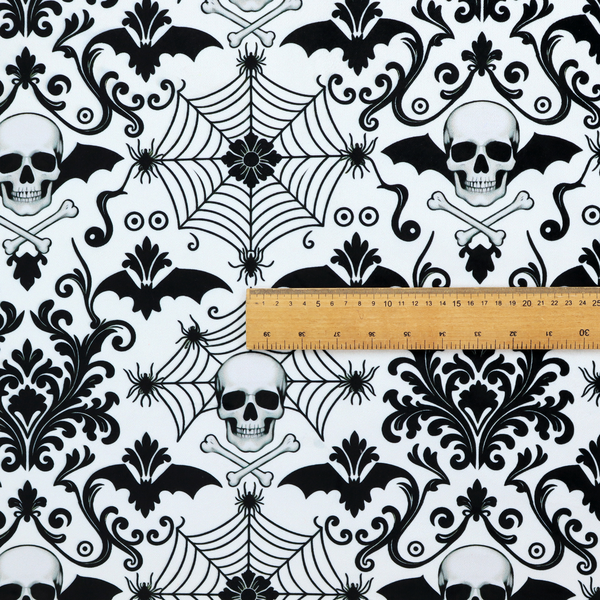 A spooky, ornate damask-style repeating pattern on a white background featuring black skulls, bats, spiderwebs with small spiders, and crossbones.