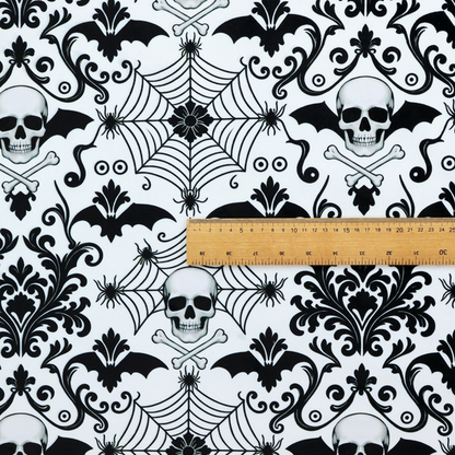 A spooky, ornate damask-style repeating pattern on a white background featuring black skulls, bats, spiderwebs with small spiders, and crossbones.